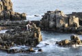 Fishermen on stone cliff